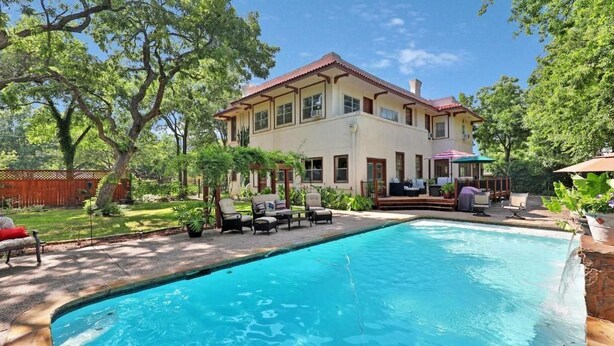 A two-story house with a swimming pool, outdoor seating, and a well-maintained garden. - Queen Size Suite with a shared Hallway Bath (Gainesville)