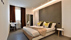 A modern bedroom with a bed, bedside table, and a desk with a chair. - 2 bedroom amazing apartment in Trappeto (Trappeto)
