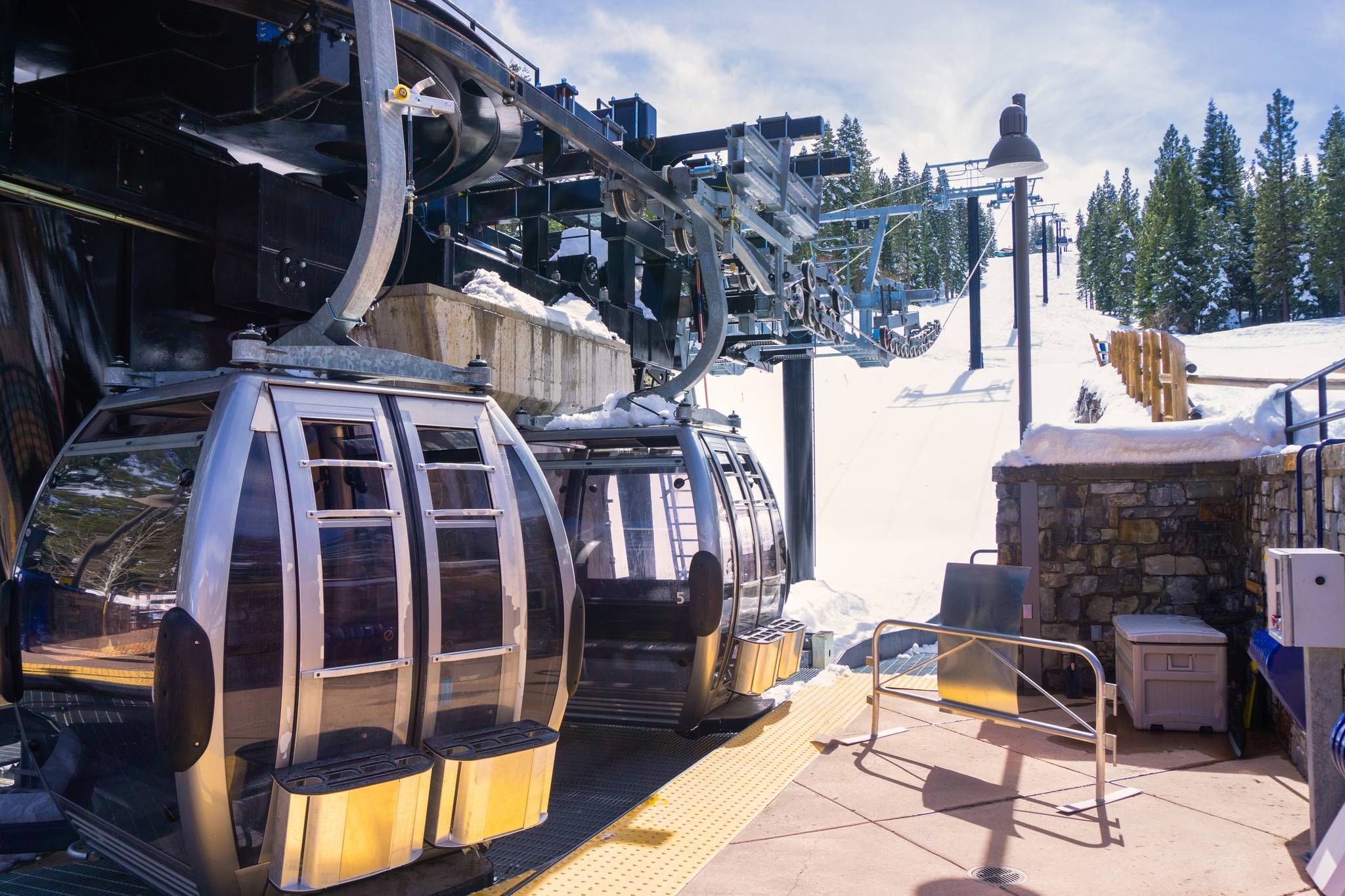 A cable car system with a stone structure and a chairlift.