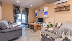 A modern living room with a sofa, a coffee table, and a TV. - Beautiful home in Ceranje Gornje (Ceranje Gornje)