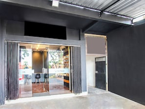 A storefront with a glass entrance, a sign indicating an Apple Store, and a metal door to the right. - Mutiara Syariah 3 (Mataram)