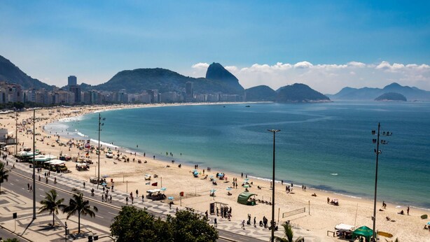 A beach with a cityscape in the background, including a prominent mountain. - A 2 Minutos de la Playa de Copacabana A801 (Rio de Janeiro)