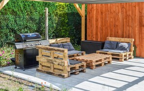 A patio with a grill, wooden furniture, and a wooden fence. - Beautiful home in Seebad Ueckermünde with WiFi (Seebad Ueckermünde)