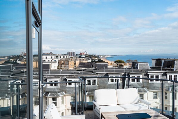 Enjoy breathtaking views of the coastal cityscape from this high-rise residence's spacious balcony.
