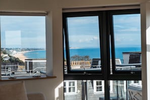 Enjoy breathtaking views of the coastal landscape from this room's expansive window.