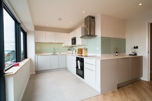 Enjoy cooking in this well-lit kitchen with an oven and microwave on a spacious island.