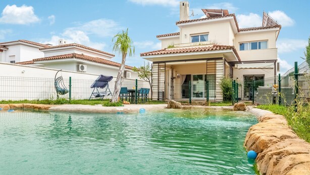 A residential area with a swimming pool, a covered patio, and a house with a tiled roof. - Beautiful home in Bollullos de la Mitaci (Bollullos de la Mitaci)