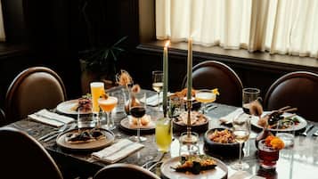 A dining table set with various dishes, glasses, and candles, indicating a formal dining experience.