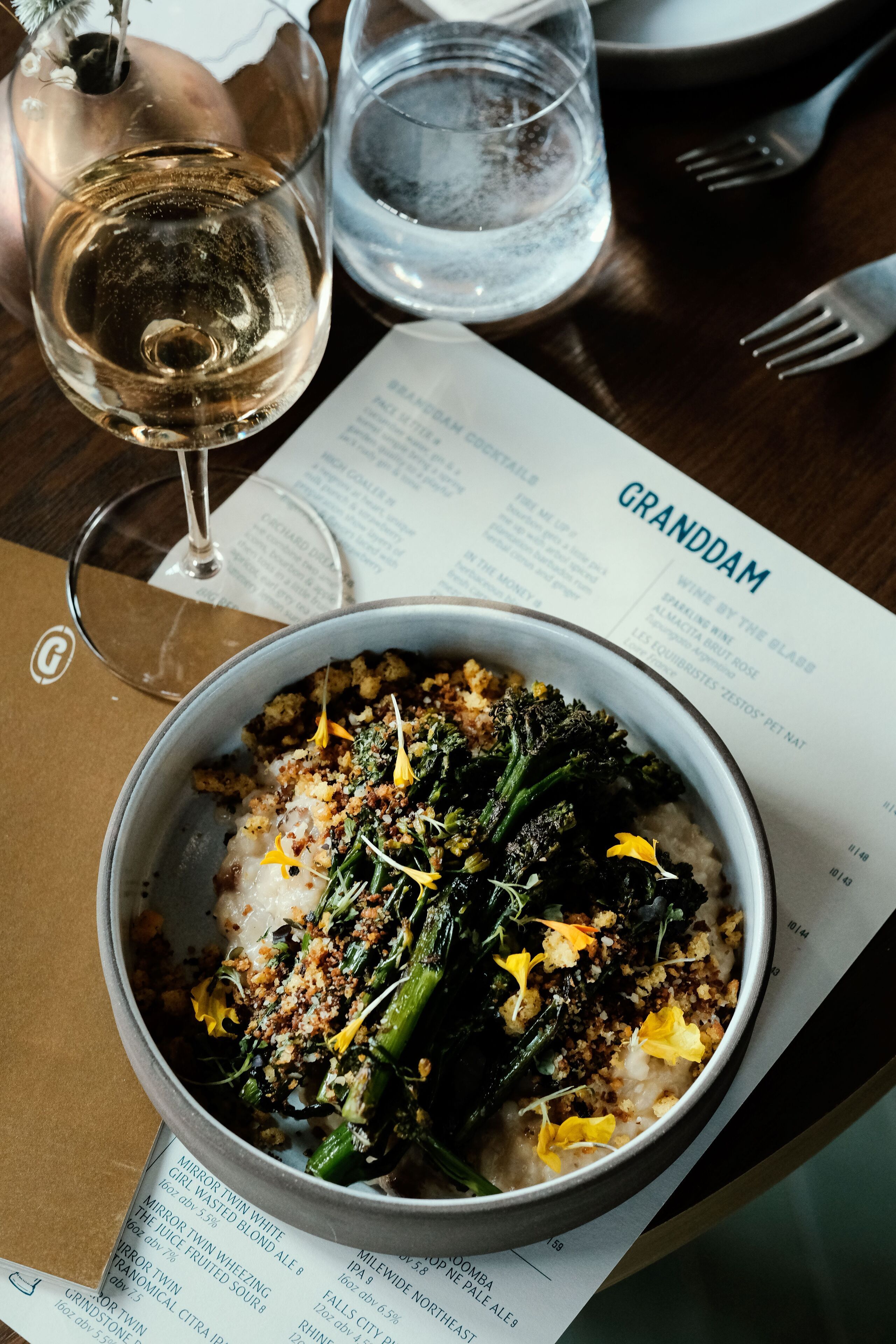 A bowl of food with a menu in the background.