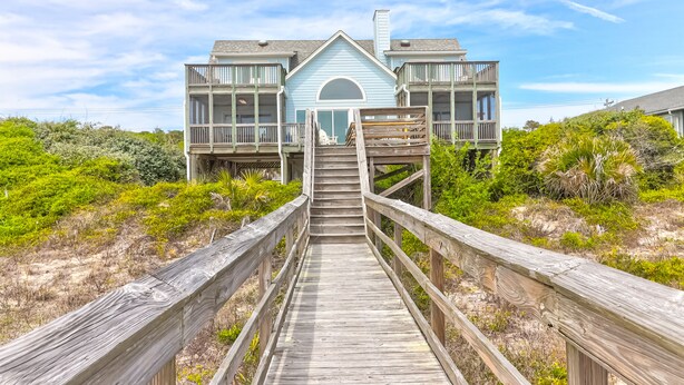 A two-story beachfront house with a wooden deck leading to the entrance. - El Mar! Beachfront - Every room is oceanfront with it's own porch & bathroom access! (Folly Beach)