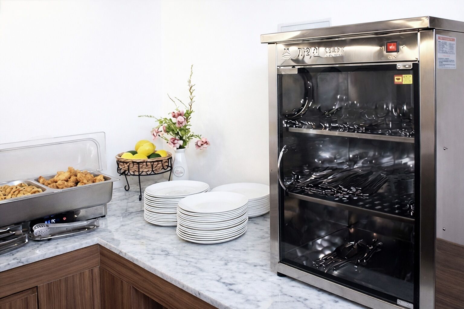 A buffet setup with food containers, plates, and a beverage dispenser.