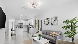 A modern apartment with a living room, kitchen, and dining area. - NAPLES GEM (Naples)