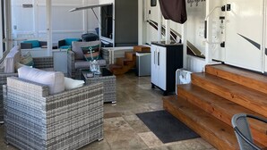 A spacious RV interior with a living area, kitchenette, and sleeping quarters. - Relax in Calusa Key Largo (Key Largo)