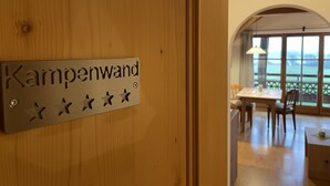 A wooden door with a sign reading "Kampenwand" and four stars. - Vacation apartment Kampenwand (Rimsting)