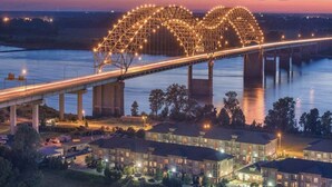 A bridge with a heart-shaped light display at dusk. - Honeymoon, The City of Music, king s Bed, B street (Memphis)