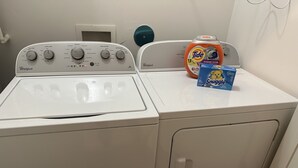 A front-loading Whirlpool washer and dryer with Tide detergent and Snuggle fabric softener. - Honeymoon, The City of Music, king s Bed, B street (Memphis)