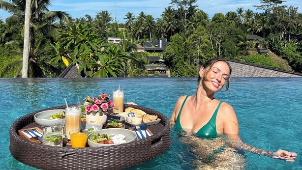 A woman in a pool with a floating tray of food and drinks. - LeRosa Valley Resort (Ubud)