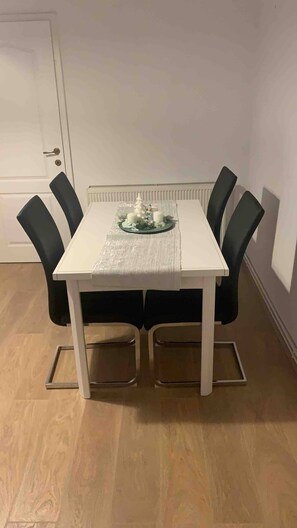 Enjoy meals in a stylish dining area with a beautifully set table and comfortable seating for four.