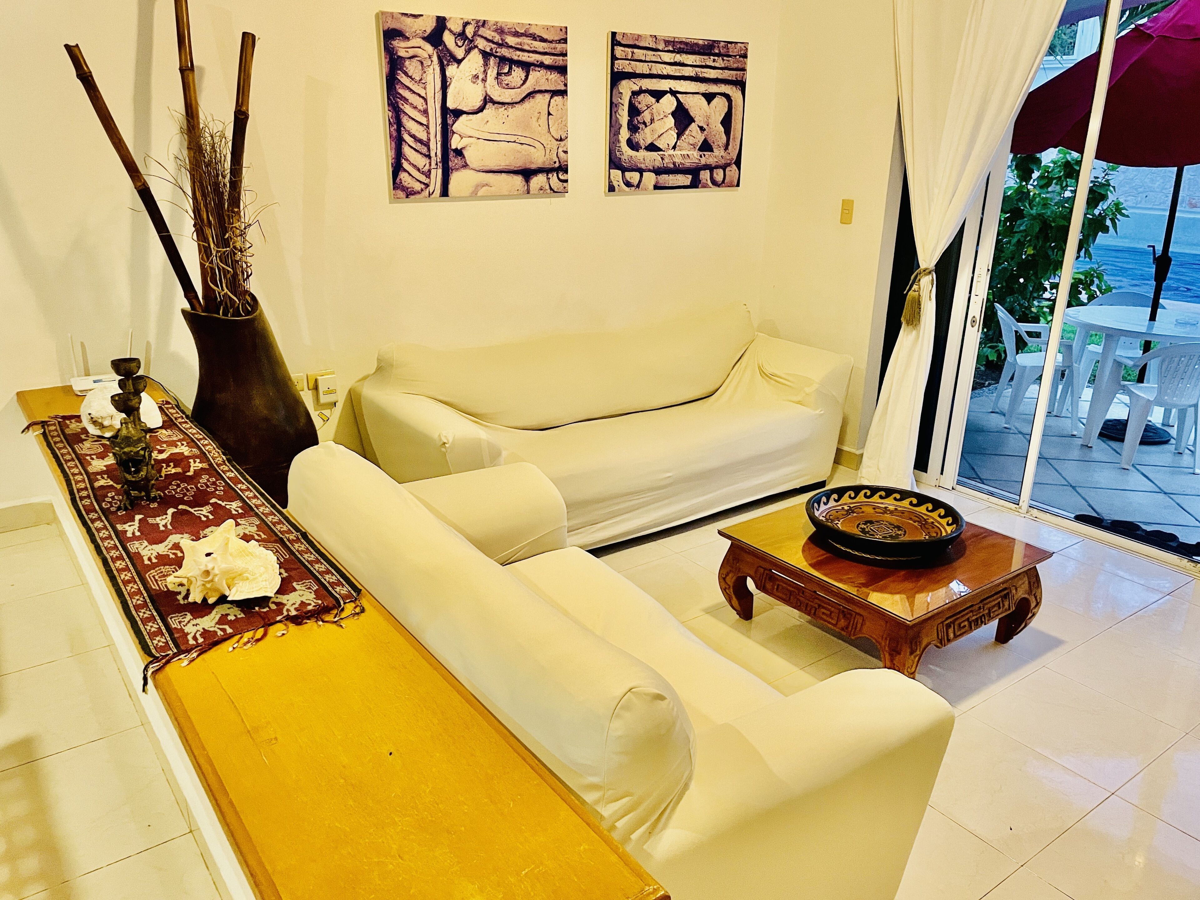 A living room with a sofa, a coffee table, and decorative items.