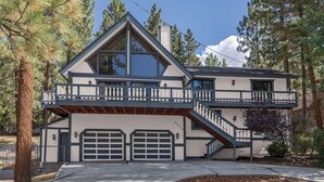 A two-story house with a balcony, a garage, and a staircase. - Centrally Located large 3 Bedrm/Available EV Charg
 (Big Bear Lake)
