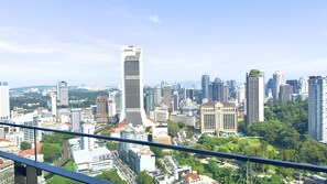 A cityscape with a prominent Maybank building, various other high-rise buildings, and a mix of commercial and residential structures. - The Robertson Residence (Kuala Lumpur)