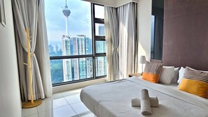 A hotel room with a large bed, a view of a cityscape, and a modern design. - The Robertson Residence (Kuala Lumpur)