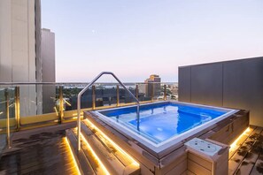 Relax by the rooftop pool with a stunning city view.