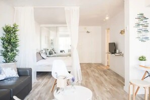 Relax in a comfortable seating area with a sofa and armchair, surrounded by a clean and minimalist design.