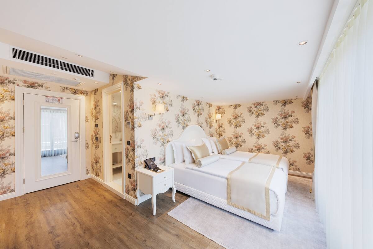 A bedroom with a bed, bedside table, and a wardrobe.