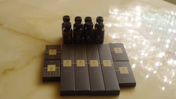 A set of black boxes with gold labels on a marble surface.