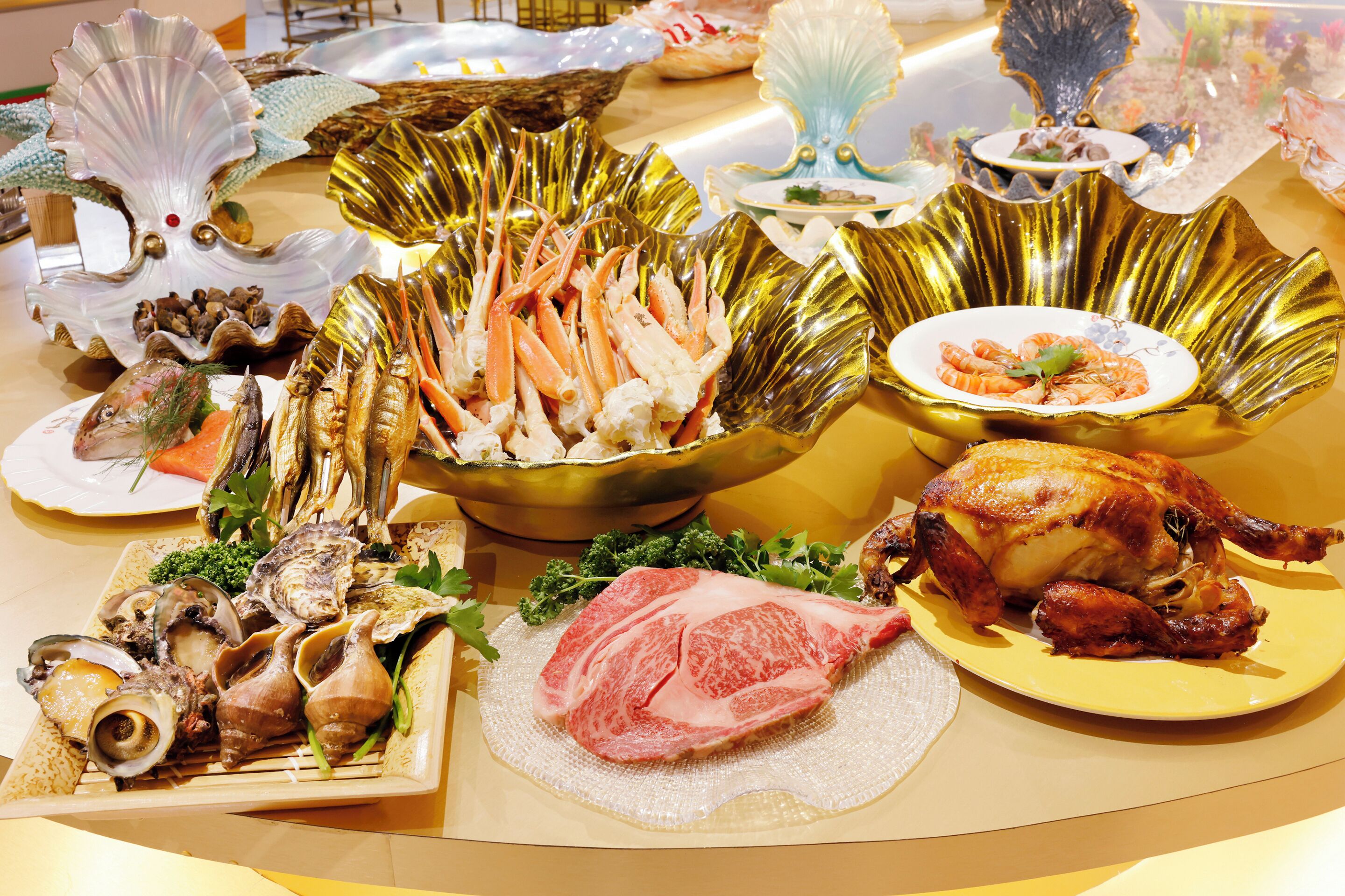A table with various seafood dishes, including shrimp and oysters, arranged on decorative plates and bowls.