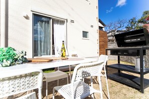 Enjoy al fresco dining and social gatherings in this outdoor patio area, complete with a barbecue grill and comfortable seating.