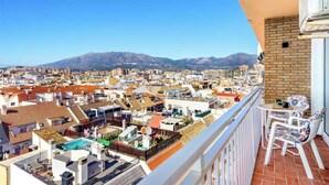 A balcony with a view of a cityscape, including buildings and mountains in the distance. - Relaxing Getaway by Costarentals - Ref 169 (Fuengirola)