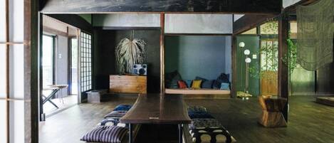 Relax in this serene space with a central table, plush seating area, and lush greenery.
