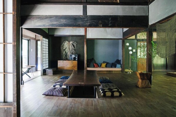Relax in this serene space with a central table, plush seating area, and lush greenery.