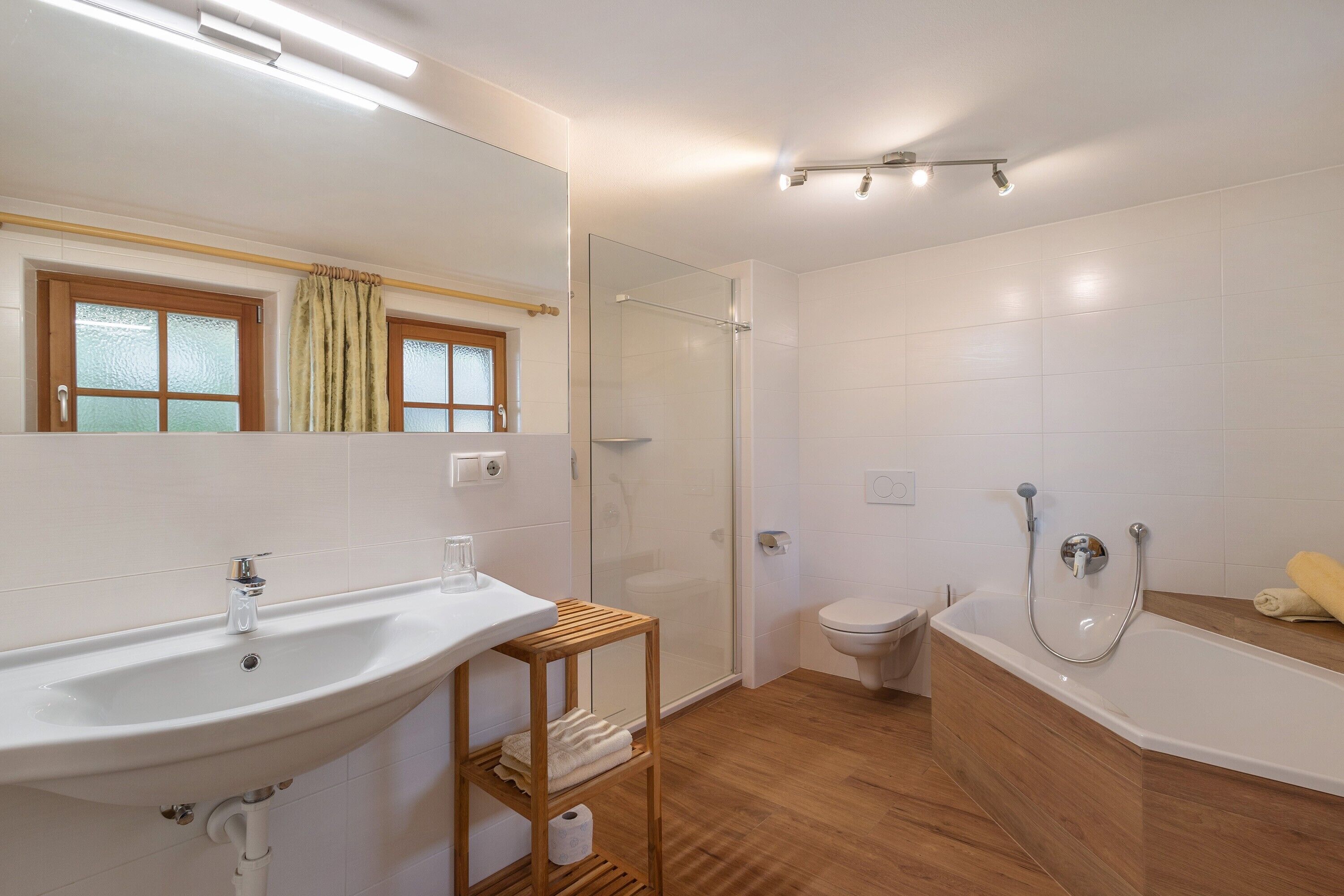 A bathroom with a sink, toilet, shower, and bathtub.