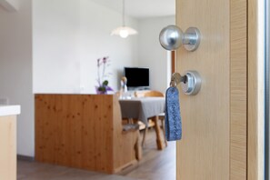 A wooden door with a keyhole and a keychain.