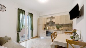 A compact living space with a kitchenette, a dining area, and a sofa. - Holiday Apartment "Antichi Ricordi - Da Angela" with Balcony, Shared Pool & Wi-Fi (Andora)