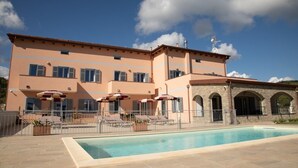 A two-story building with a swimming pool, outdoor seating, and stone arches. - Holiday Apartment "Antichi Ricordi - La Stalla" with Terrace, Shared Pool & Wi-Fi (Andora)