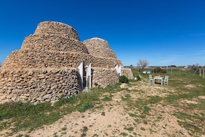 A stone structure with a staircase leading up to a door.