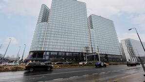 A modern glass building with a curved facade, likely a commercial or office building. - Modern Studio with Balcony | Parking | Close to EXPO XXI (Warszawa)