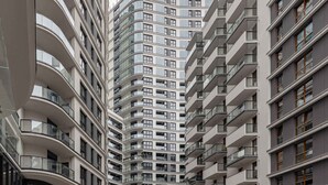 A high-rise residential building with multiple balconies and large windows. - Modern Studio with Balcony | Parking | Close to EXPO XXI (Warszawa)
