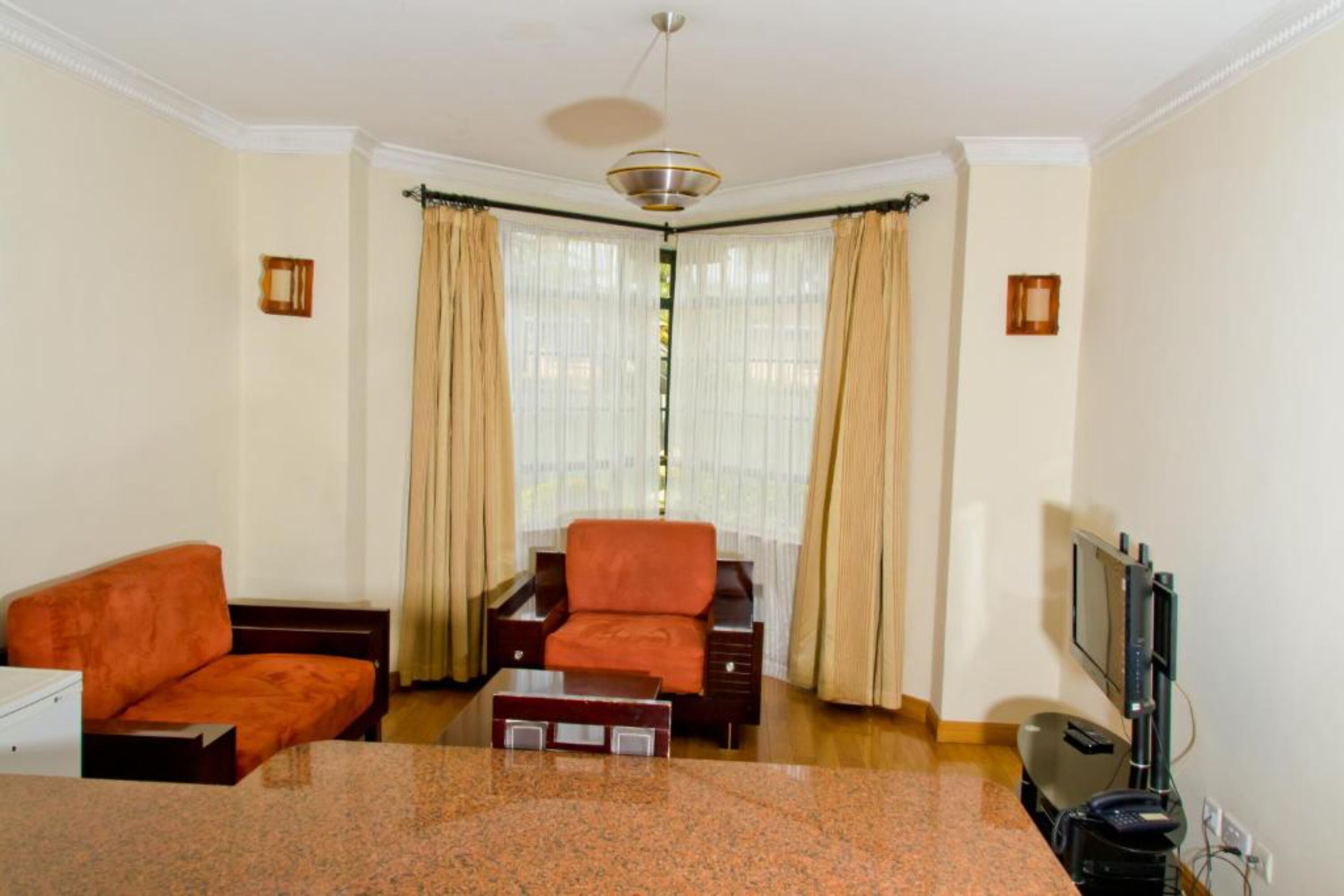 A living room with a sofa, a coffee table, and a TV.