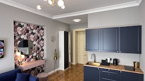 A modern kitchen with dark cabinets, a wooden countertop, and a built-in sink.
