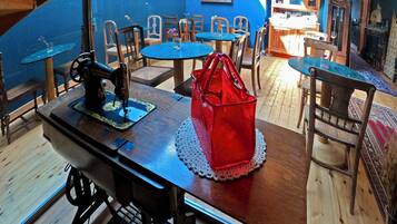A dining area with a wooden table, chairs, and a sewing machine.