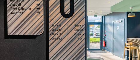 A directional sign with room numbers and corresponding amenities.