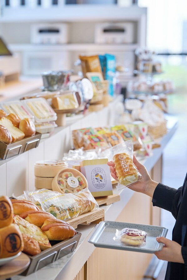 A bakery counter with various baked goods and packaged items.