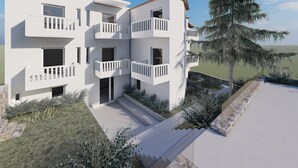 A modern multi-story building with balconies, a driveway, and a large tree. - Cost Mari Boutique Hotel  (Apokoronas)