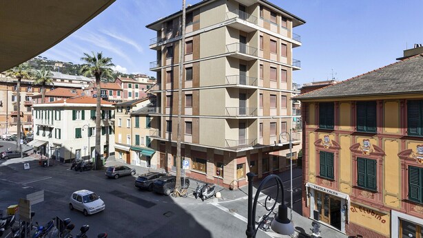 A multi-story building with balconies, a street view, and parked vehicles. - In the Heart of Santa Margherita by Wonderful Italy (Santa Margherita Ligure)