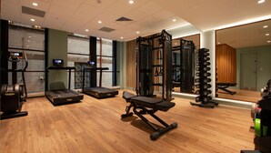 A gym with treadmills, weight machines, and a squat rack. - The Address Glasgow (Glasgow)